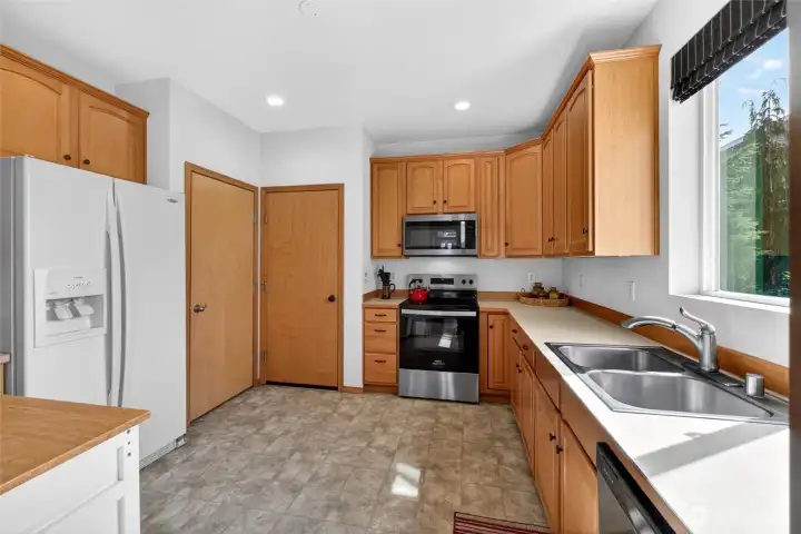 Pantry to the right of the fridge. The other door leads to the garage.