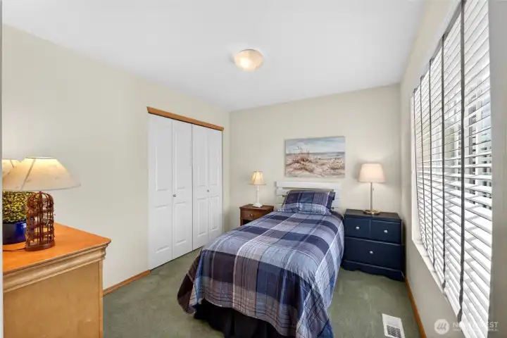 Upstairs guest bedroom looks out over the beautiful yard