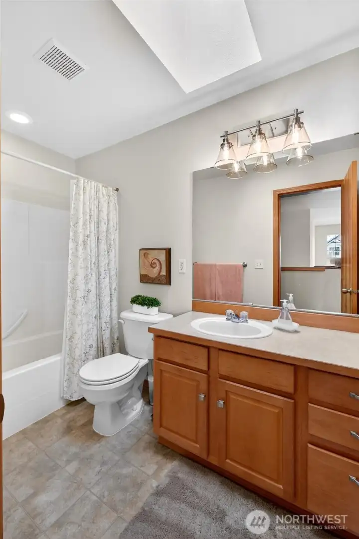 Upstairs guest bath with a skylight for plenty of light