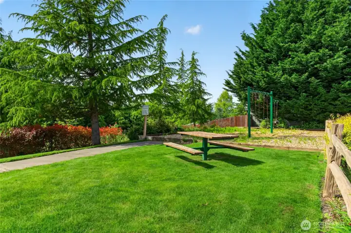 This small park is beyond the back fence of this home. Picnic, anyone?