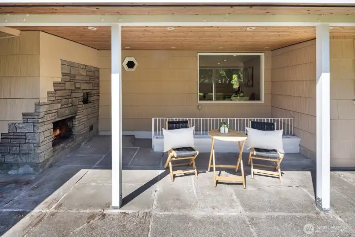Covered Patio behind the house overlooks spacious yard.  In-Chimney fireplace and stairs lead to basement laundry.