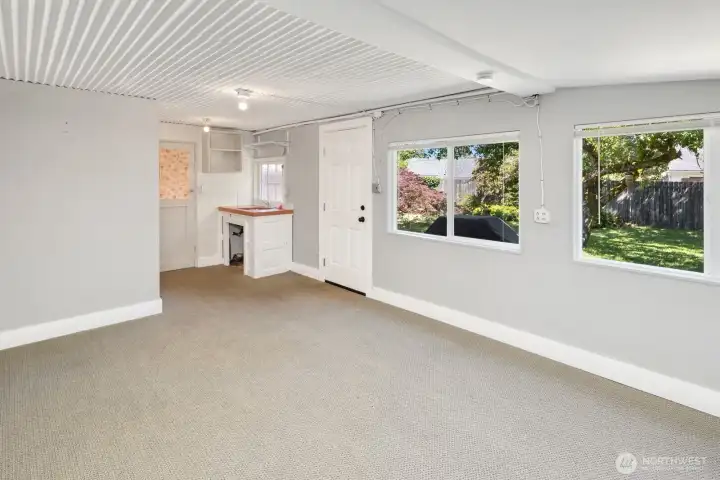 Cabana's two doors - one leads to backyard garden, and one leads into the garage.  Great indoor-outdoor option for someone who likes to spend time fixing cars, watching the game, or working out in the garage.