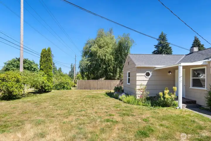 The front of the home offers a large yard with lots of sun for more outdoor adventures.