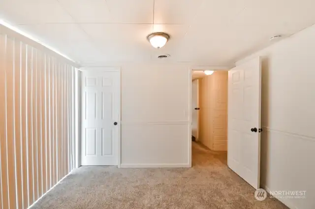 3rd bedroom with walk-in-closet at rear of home and french doors to the patio