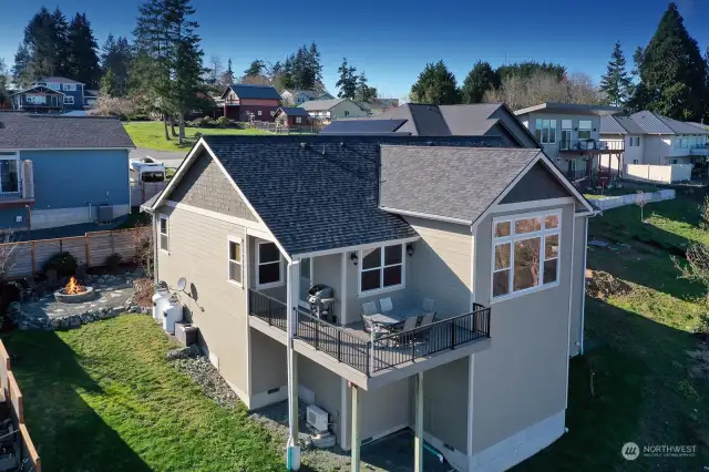 Southeast view of the home, great perspective on the abundance of windows and how much space is available for a potential lower level expansion. Trex deck has a propane hook up for your BBQ grill.