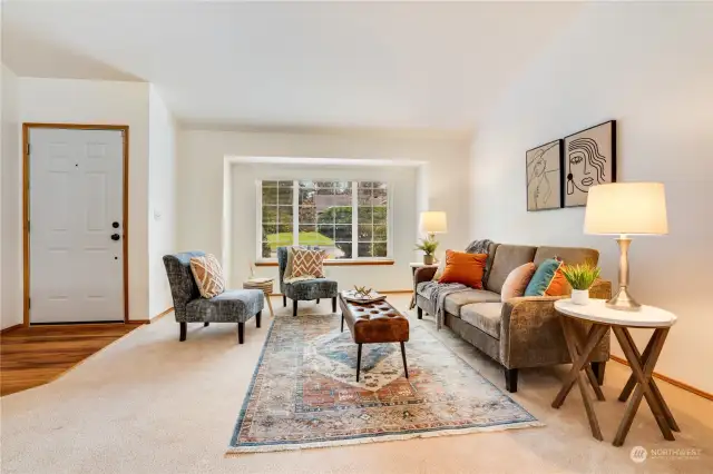 Step into a warm and inviting entryway featuring luxury vinyl flooring, perfect for welcoming guests on those rainy northwest days. Newly cleaned carpets and a vaulted ceiling add a fresh and airy feel to the home.