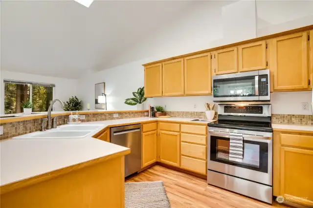 Searching for an open floor plan perfect for entertaining? The kitchen, featuring updated stainless-steel appliances and luxury vinyl flooring, offers plenty of opportunities to engage with guests while preparing meals.