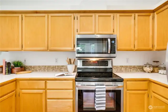 Look at all the cabinets and counterspace! The tile backsplash complements the cabinets and countertops.