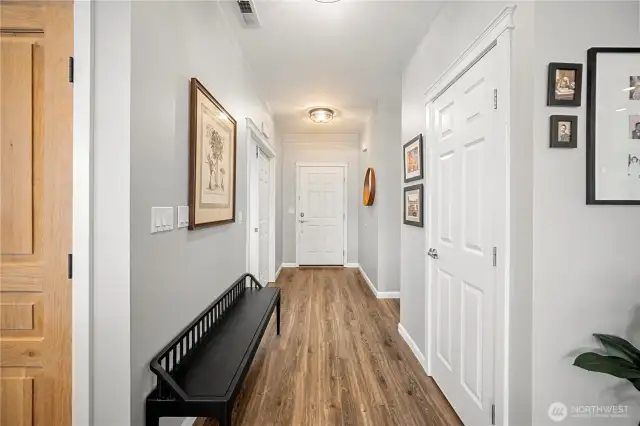 Looking back at entry.  Closet on the right, then hall leading to full bathroom and guest bedroom.  French doors on the left past the bench lead to the office.