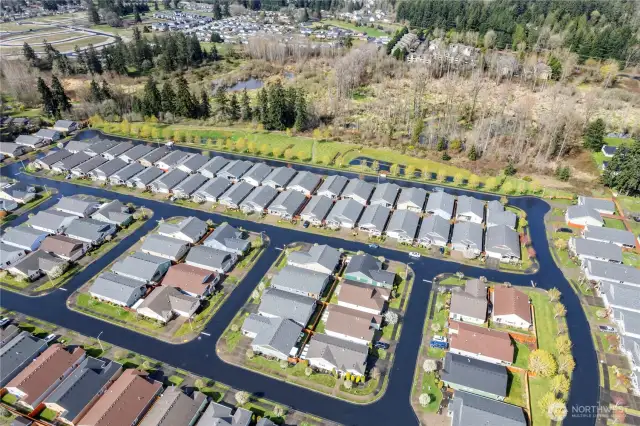 An aerial view of part of the community.  Along the back street is a park, picnic area with gazebo.  Great place to take a walk.