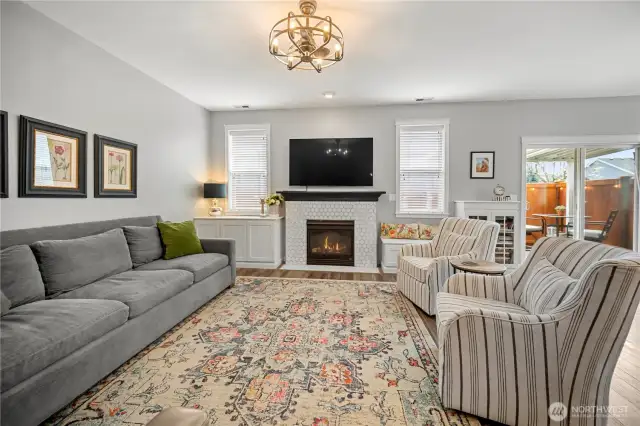 The gas fireplace with hearth has been beautifully tiled.  Custom built-ins on either side to include a window seat and bookcase.