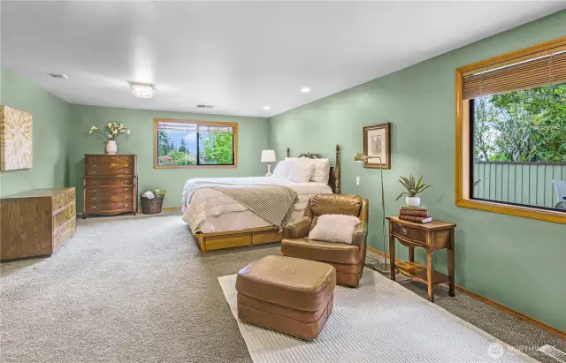 Spacious Primary Bedroom Suite: A luxurious retreat featuring an expansive layout with a cozy sitting area—perfect for relaxation, reading, or enjoying peaceful morning coffee in your own private sanctuary.