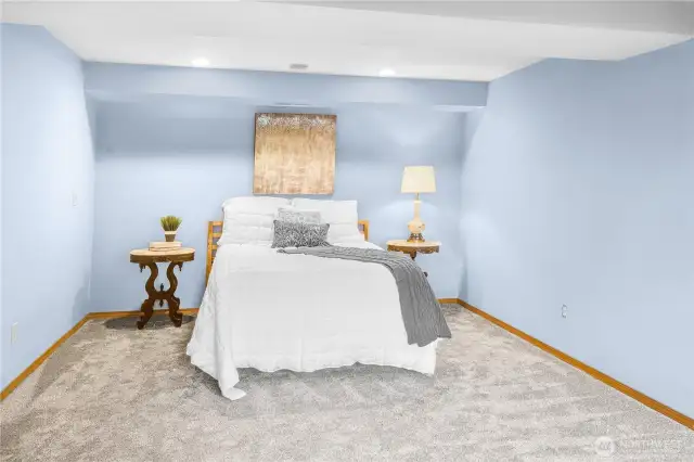 Alternate View of the Lower-Level Bedroom Retreat: A generous, inviting space with a cozy sitting area—ideal for unwinding, reading, or enjoying a quiet moment in comfort.