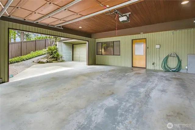 Spacious Car Storage: Semi-enclosed two-car carport with a garage door, plus an additional third garage.