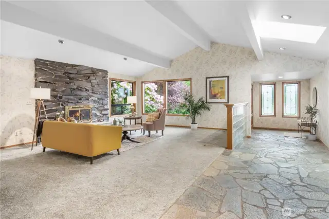 Expansive Living Room: A grand, open-concept space seamlessly connected to the welcoming entryway and stylish hallway wet bar, perfect for entertaining and comfortable everyday living.