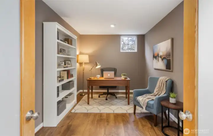 Virtually staged den sits behind frosted glass French doors off the living room. It’s large enough for a huge office or a guest room. Add a Murphy bed for flexibility if you’d like.