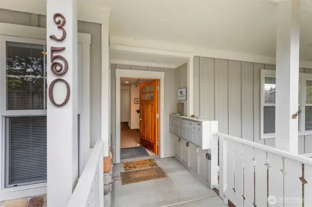 Front entry with mailboxes into lobby with storage units & lower elevator