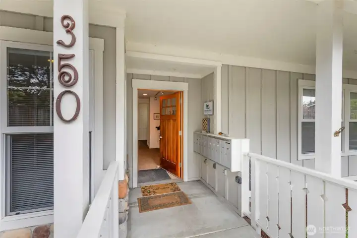 Front entry with mailboxes into lobby with storage units & lower elevator