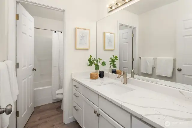 The guest bath on the upper floor with updated counters.