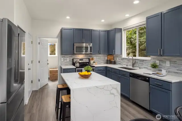 Chef's kitchen with newer counters and appliances.