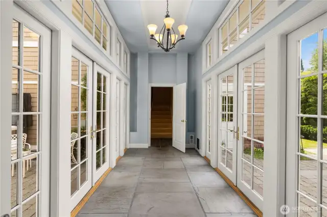 Atrium just off the family room that leads to the garage, a 2nd elevator and the guest house.
