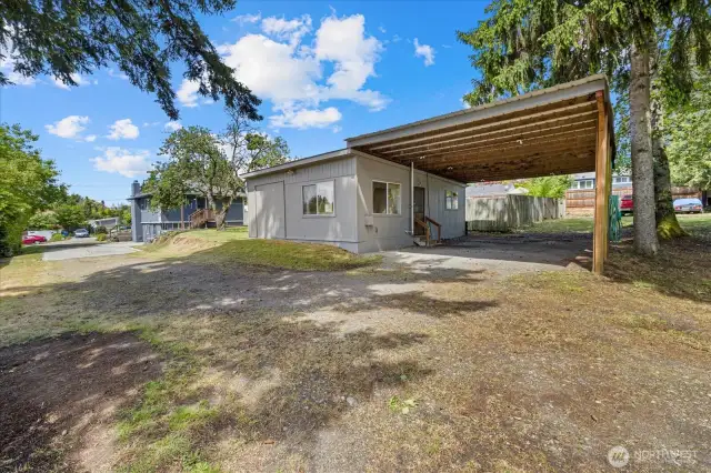 Behind the main house is this cottage with a carport