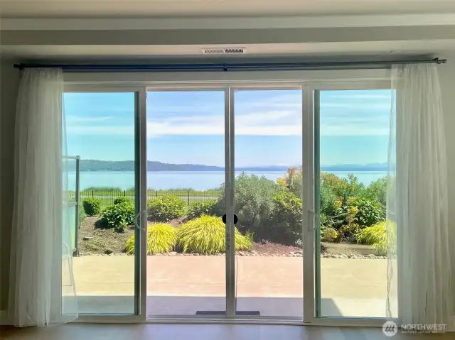 UNOBSTRUCTED WATERFRONT VIEW! A spectacular, corner garden-level condominium like this one is rarely available.  Picture yourself enjoying coffee or cocktails while taking in this breathtaking front row view just a few grassy steps from the tranquil waters of Puget sound.  The Century Condominiums is located in the heart of the fun at Point Ruston.