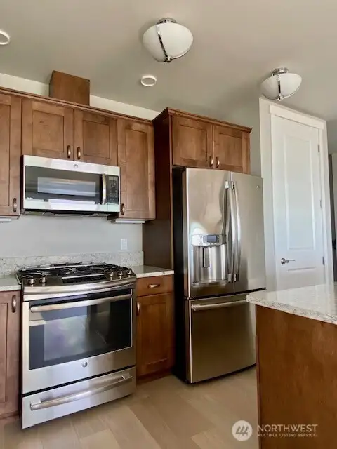 All Appliances including dishwasher, GAS range, refrigerator, garbage disposal and washer/dryer to stay!  Door to the right is a spacious pantry...super convenient for storage!