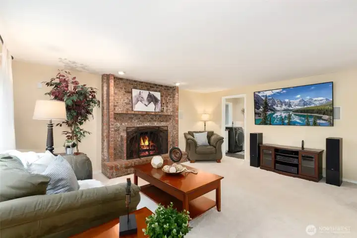Family room with second wood burning fireplace.