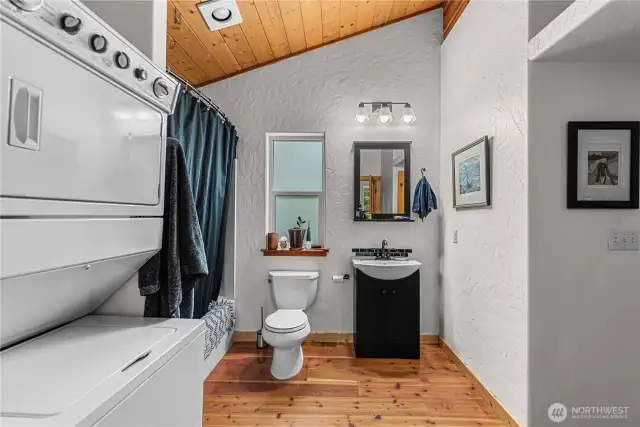 This well-appointed bath and laundry combo makes the apartment above the garage fully self-sufficient - offering convenience, comfort, and rustic charm all in one beautifully designed space.