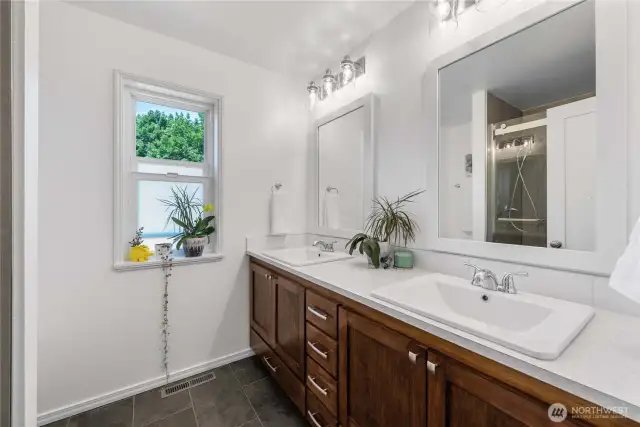 Sunlit Master Bathroom with Refreshing Window Views.