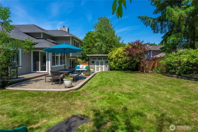 Peaceful Backyard Setting with Lush Green Surrounding.