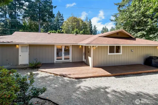 Back deck w/access from garage, primary, hallway door and around side of garage