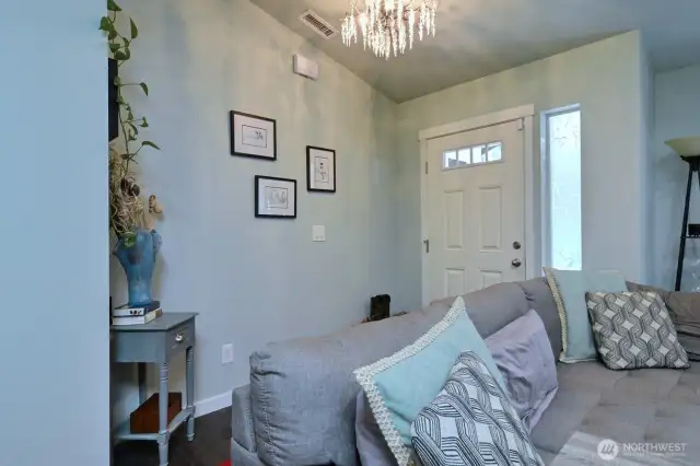 The front door opens up into the open-concept living room, kitchen and dining area