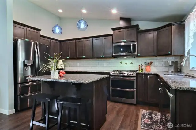 Lots of counter and cooking space. Stainless appliances, double oven, granite, stainless and subway backsplash.