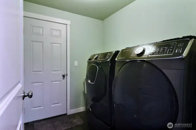 Laundry room off kitchen/living room. With access to the attached garage.