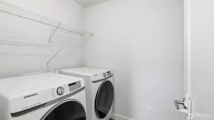 Upper-level laundry room offers easy access and efficient workspace.