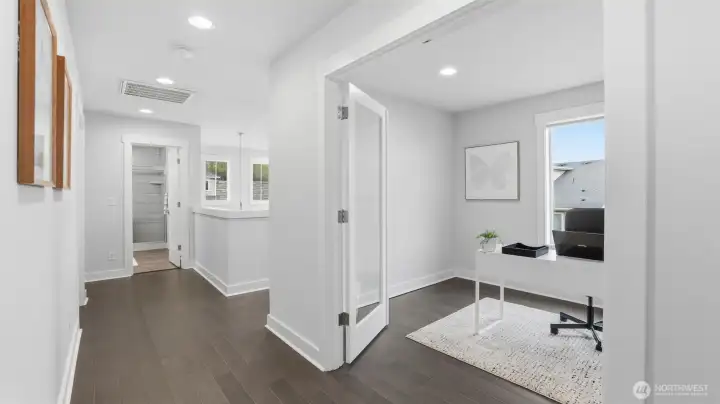 This spacious upper hallway offers great flow with a light-filled office right off the landing.