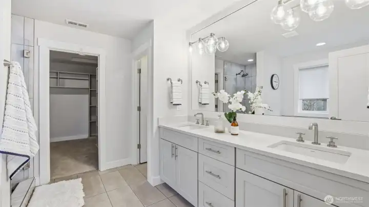 Enjoy a bright and beautifully finished primary bath with double sinks and ample storage