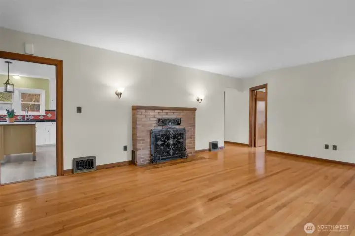 Enter into the large stately living room w/wood burning fireplace.