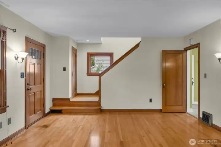 Front door; coat closet at landing of stairs to second floor.