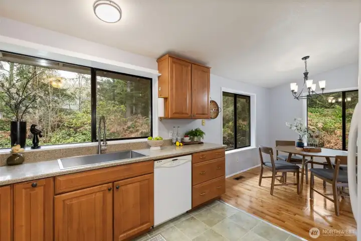 Well-kept maple cabinetry and Silestone countertops and a brand new deep stainless steel sink.