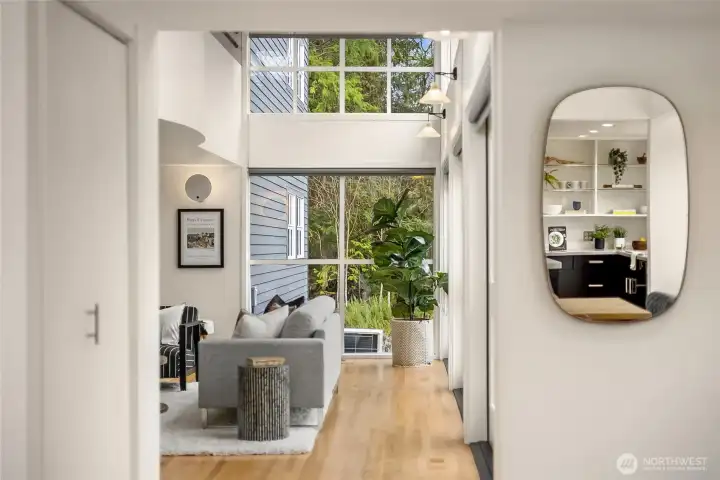From the Entry towards Living room. Light flooding the living spaces through three sets of French Doors.