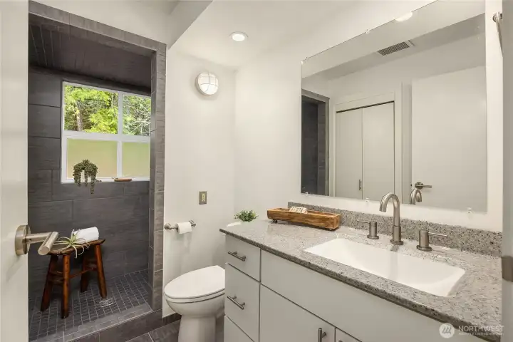 The primary bath on the main level offers a fully tiled walk -in shower.