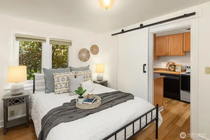 bedroom upgrades include new floors, paint and a barn door