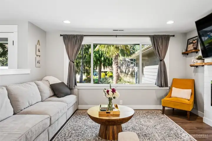 This is one of those windows that changes how a room feels. The oversized picture window pulls in sunlight all day and gives you a clear view of that standout palm tree in the front yard, adding a little unexpected charm to the setting. The space feels bright and inviting without trying too hard. You’ll also notice the ceiling heat registers, a small detail that makes a big difference when it comes to arranging furniture. With a gas furnace and heat pump handling the climate, the home stays comfortable through every season, warm when you want it, cool when you need it.