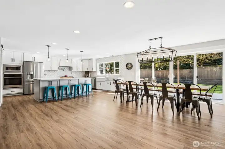 You’ve got a full dining setup for 12 that still feels comfortable, and it flows right into a beautifully open kitchen that keeps everyone connected. The oversized island adds seating for at least four more, so whether it’s casual breakfasts or guests gathering while you cook, there’s plenty of room for it all. There’s also extra storage built into the seating side of the island, which is one of those details that makes a big difference in everyday use. The cabinetry throughout features soft-close drawers and doors, adding that smooth, quiet finish that speaks to the quality of the remodel.