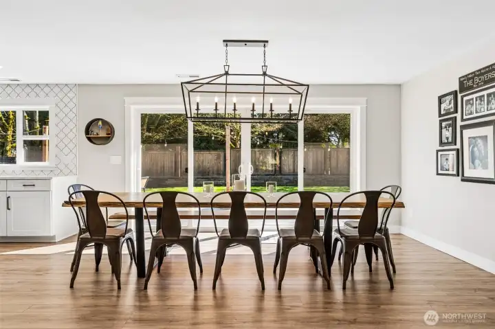 This is the kind of dining space that makes hosting feel easy. It’s expansive enough to handle a full table for 12 without feeling crowded, and the clean, modern chandelier keeps the look fresh and elevated. The large sliding glass door brings in tons of natural light and offers a full view of the backyard, but it’s the wide opening capability that really changes how the space lives. Open it up and the deck becomes an extension of the dining area, perfect for moving guests in and out or just enjoying that open-air feel. It has a relaxed, resort-like energy that makes everyday meals feel a little more special.
