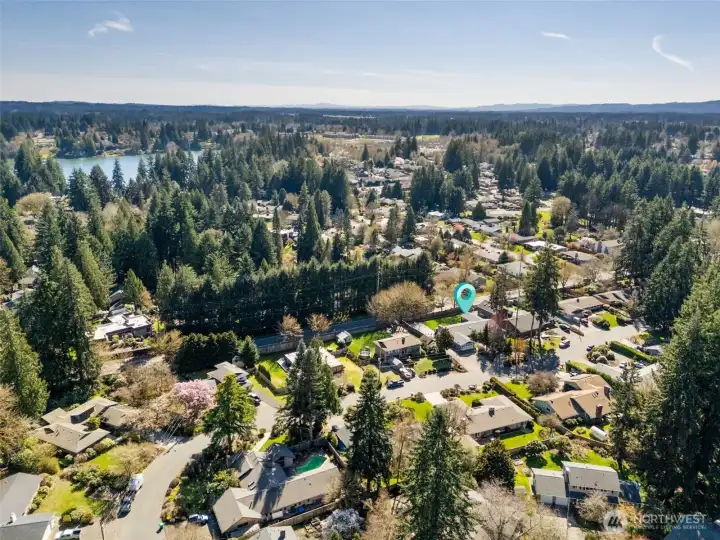 From this southwest aerial, the neighborhood really shows off what makes it special, with larger lots, mature surroundings, and a layout that feels intentional.  This home benefits from that extra breathing room both visually and functionally. In the distance, you can spot Ward Lake, and with public access just a few minutes away off Boulevard Road, it’s easy to picture summer swims, paddle days, or casting a line after work. It’s one of those quiet lifestyle perks that ends up getting used more than expected. Between the proximity to the lake, the established feel of Braemar, and the location right in Olympia’s golden triangle with walkability to Pioneer Elementary, Washington Middle, and Olympia High, this is a setting that continues to check all the right boxes.