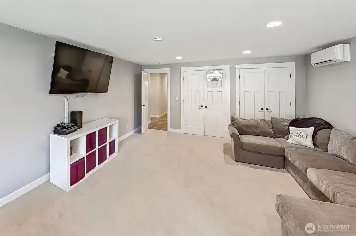 This bonus room is where flexibility really shows off. At roughly 15 by 25 feet, it’s a true oversized space that can handle whatever you throw at it, media room, game zone, second living area, or a place to spread out and unwind. Two French door closets add extra storage without sacrificing style, and three front-facing windows keep the room bright with great natural light, softened by wide slat blinds for privacy when you want it. The soft dove gray walls and latte-toned carpet keep the palette consistent and comfortable, while recessed lighting overhead makes it easy to use the space day or night.